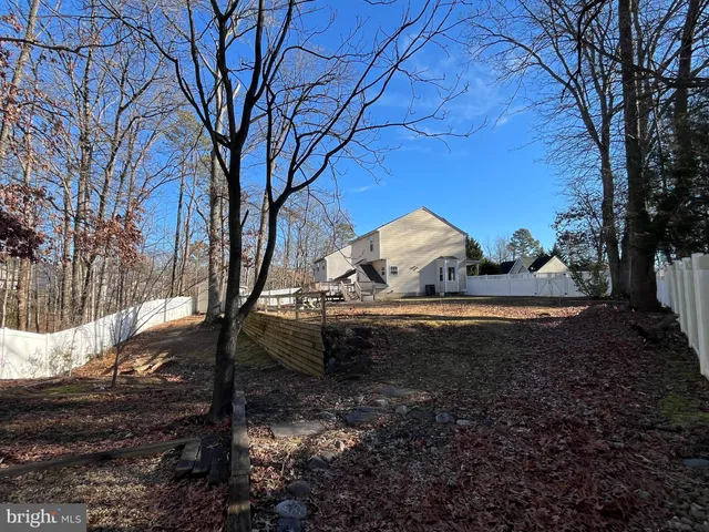 a view of yard with tree in the background