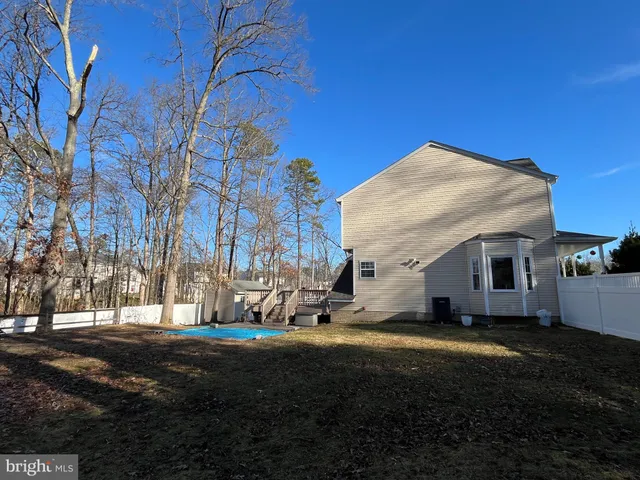 a view of house with backyard