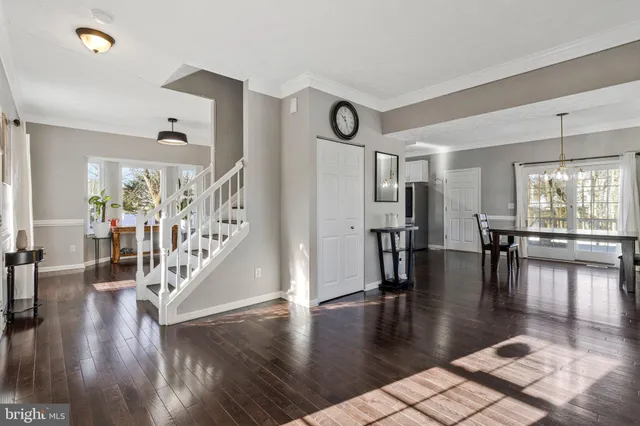 a view of dining room with hardwood floor and a large window