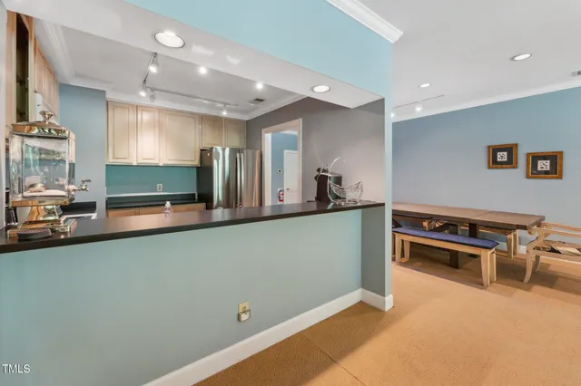 a kitchen with stainless steel appliances granite countertop a stove a sink and a granite counter tops with white cabinets