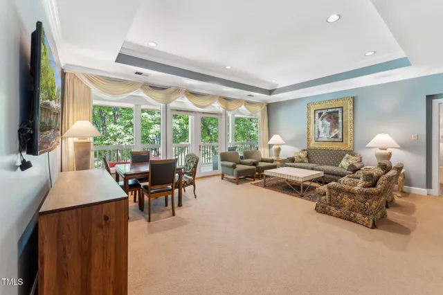 a spacious bedroom with a bed and a chandelier