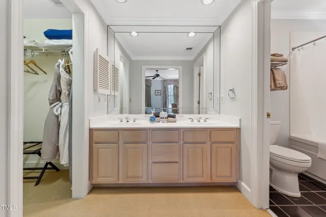 a spacious bedroom with a bed and a chandelier
