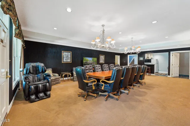 a spacious bedroom with two beds and a chandelier
