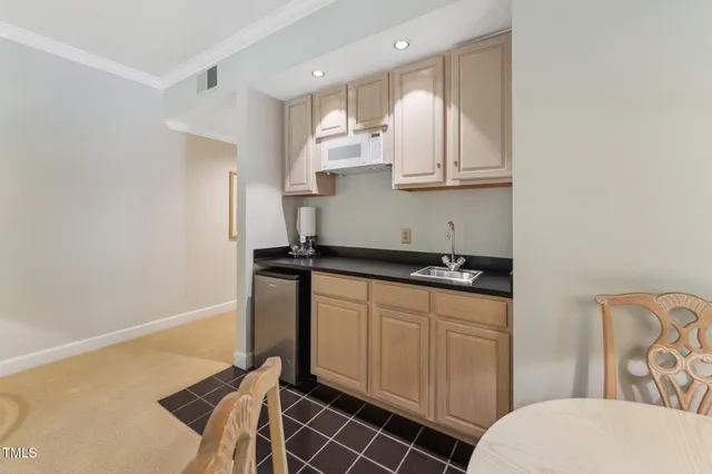 a kitchen with stainless steel appliances granite countertop a stove refrigerator and sink