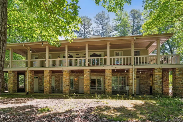a bedroom with two beds and a chair