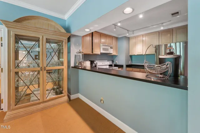 a kitchen with appliances a sink and cabinets