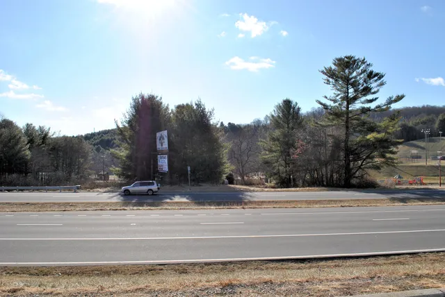 a view of outdoor space with lots of swings and slides
