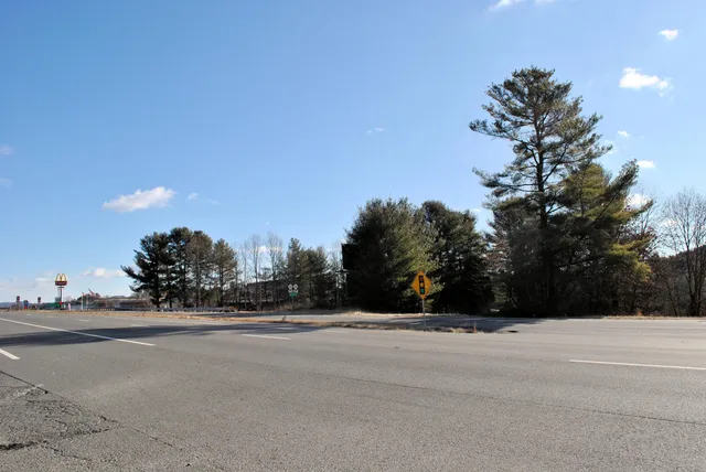 a view of a street with a building in the background