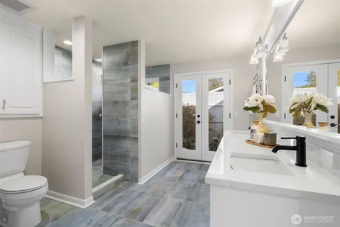 a spacious bathroom with a shower and toilet