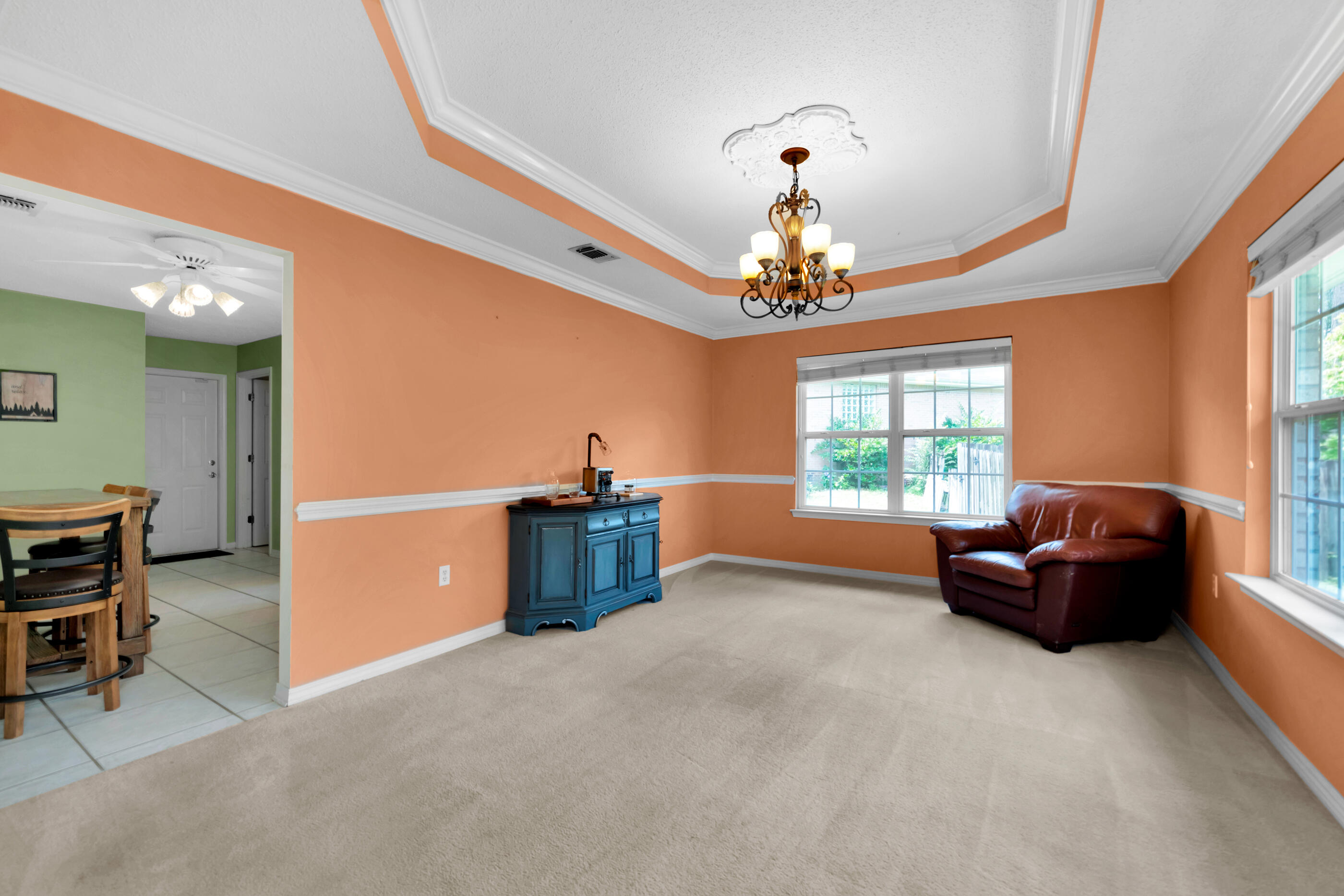 738 Riva Ridge Drive Crestview, FL 32539 - Photo 12 of 23 a living room with furniture a chandelier and a window
