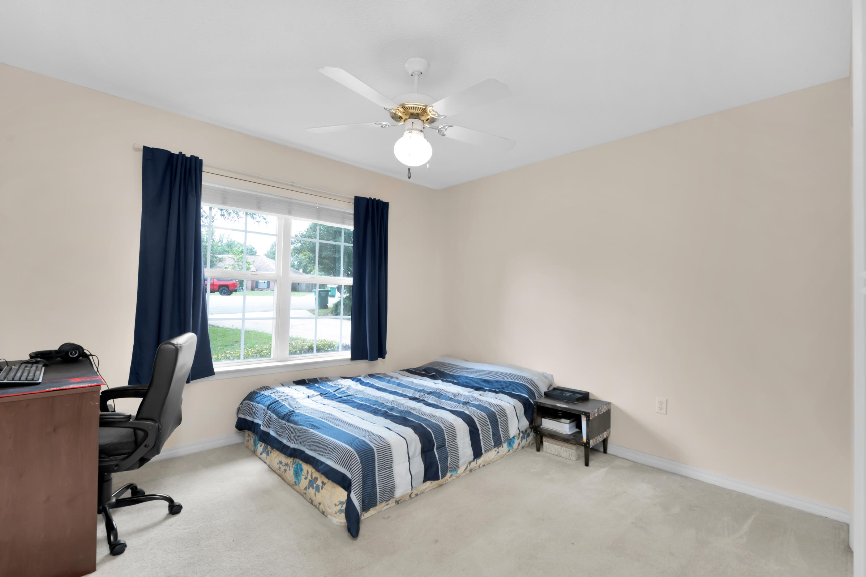 738 Riva Ridge Drive Crestview, FL 32539 - Photo 19 of 23 a bedroom with a bed and a chandelier