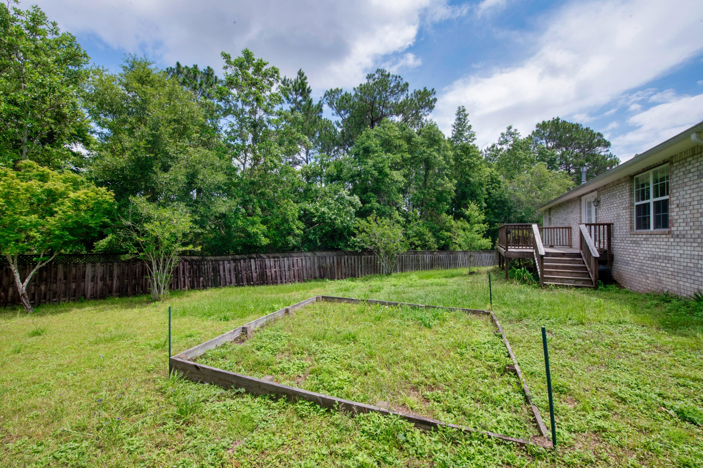 738 Riva Ridge Drive Crestview, FL 32539 - Photo 23 of 23 a view of a backyard with plants and a backyard