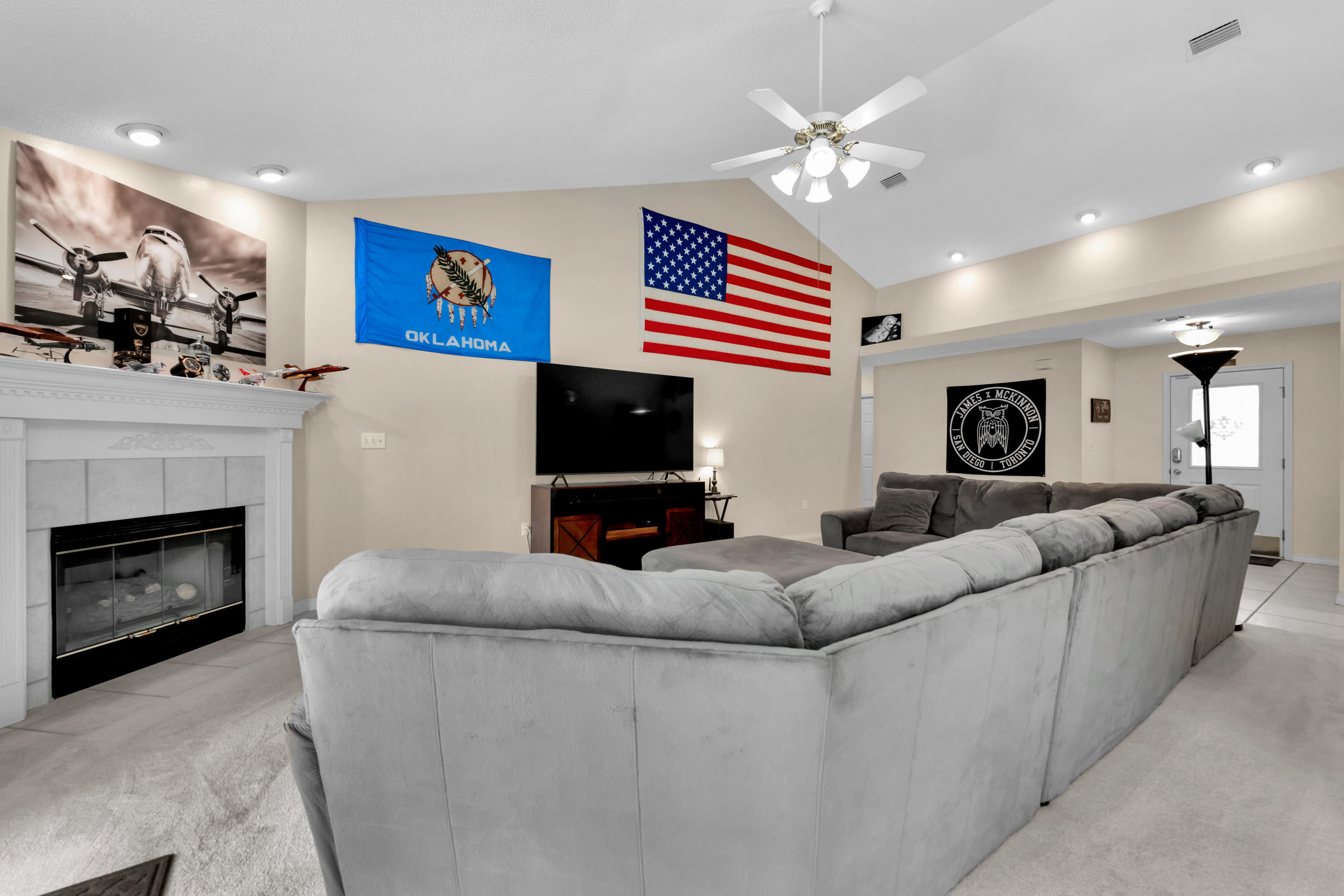 738 Riva Ridge Drive Crestview, FL 32539 - Photo 6 of 23 a living room with furniture a fireplace and a flat screen tv