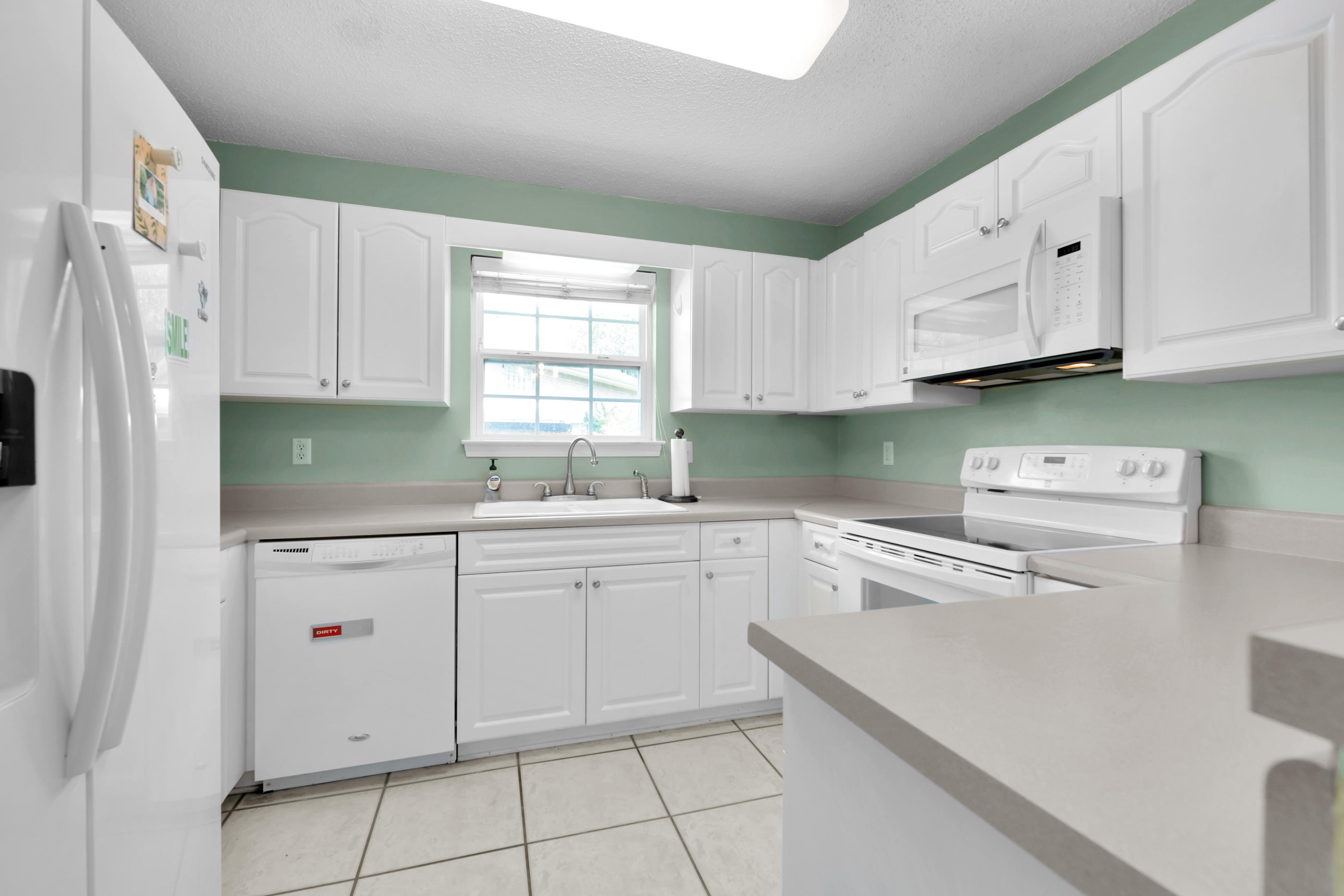 738 Riva Ridge Drive Crestview, FL 32539 - Photo 7 of 23 a kitchen with granite countertop white cabinets and white appliances