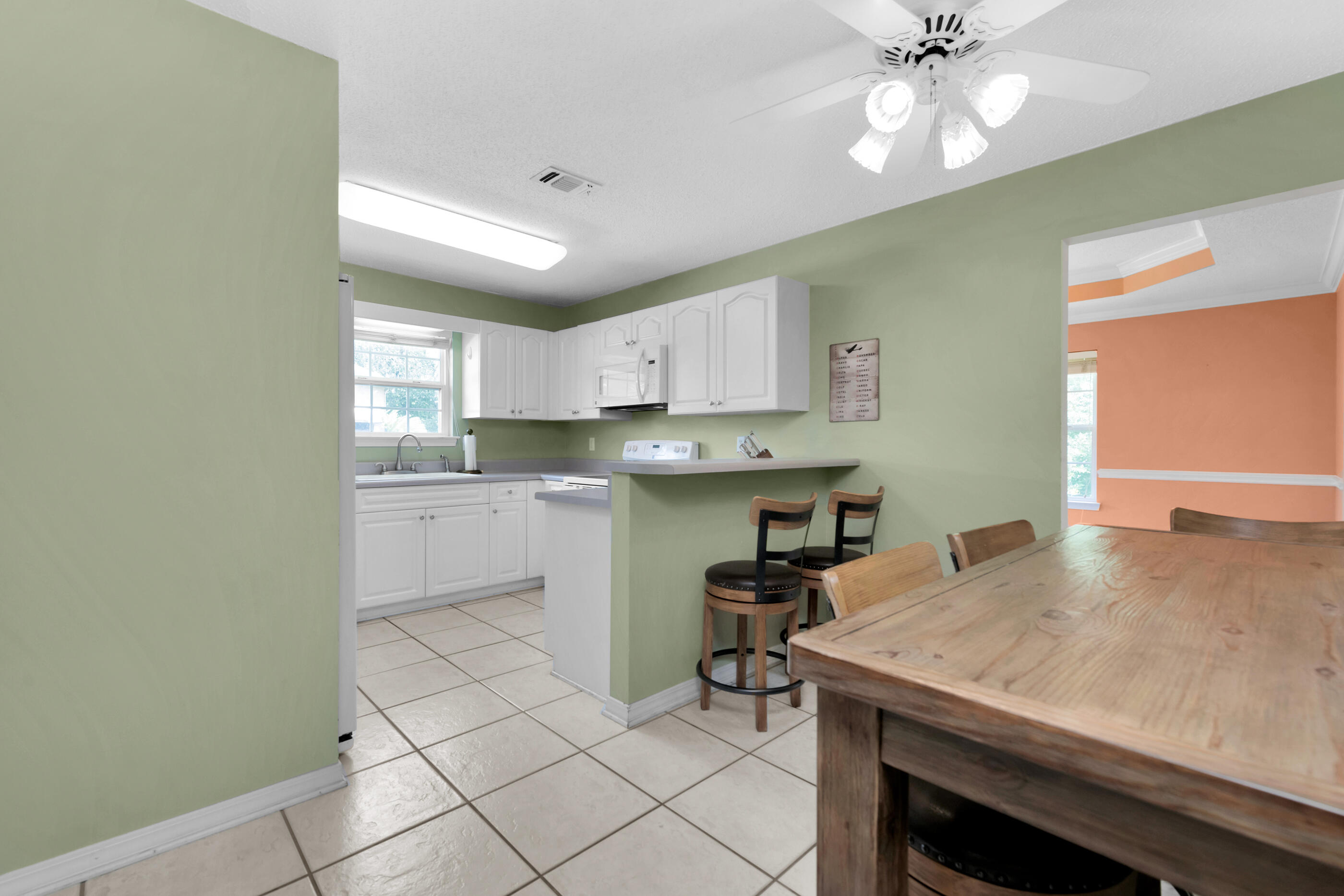 738 Riva Ridge Drive Crestview, FL 32539 - Photo 8 of 23 a kitchen with a table chairs microwave and cabinets