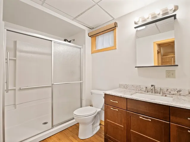a bathroom with a toilet sink vanity and mirror