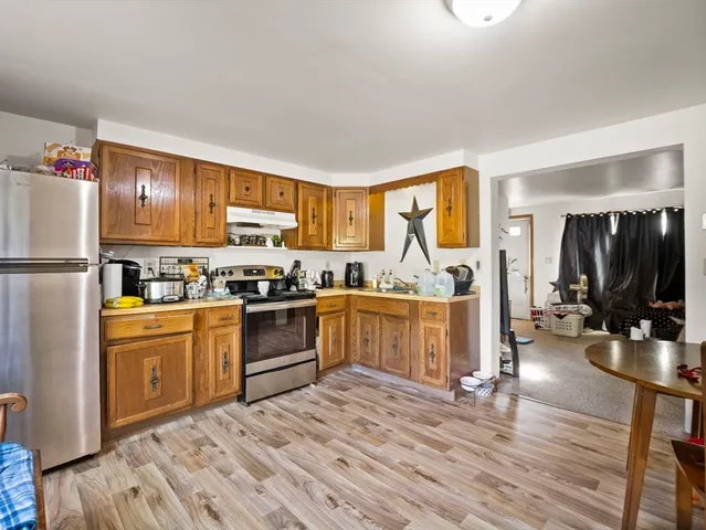 a kitchen with sink refrigerator and cabinets