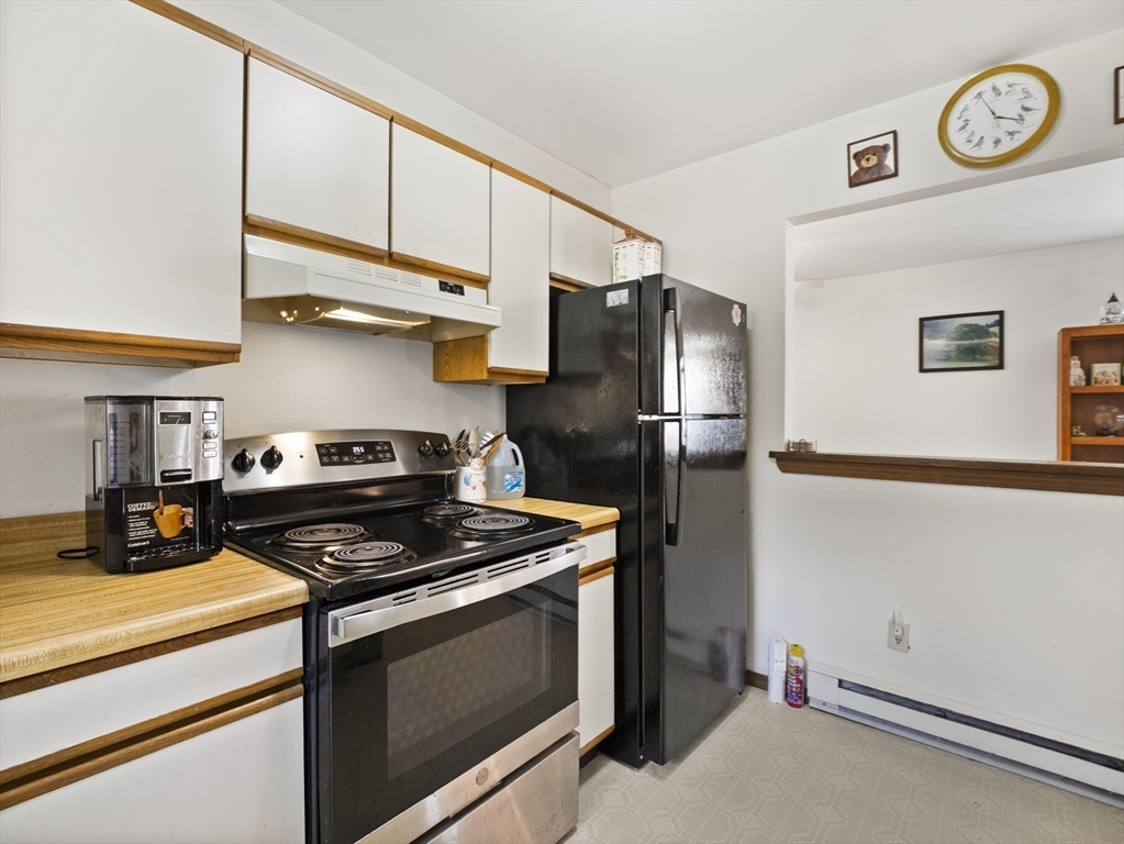15 South Holden Road Warwick, MA 01378 - Photo 34 of 42 a kitchen with stainless steel appliances a stove a refrigerator and cabinets