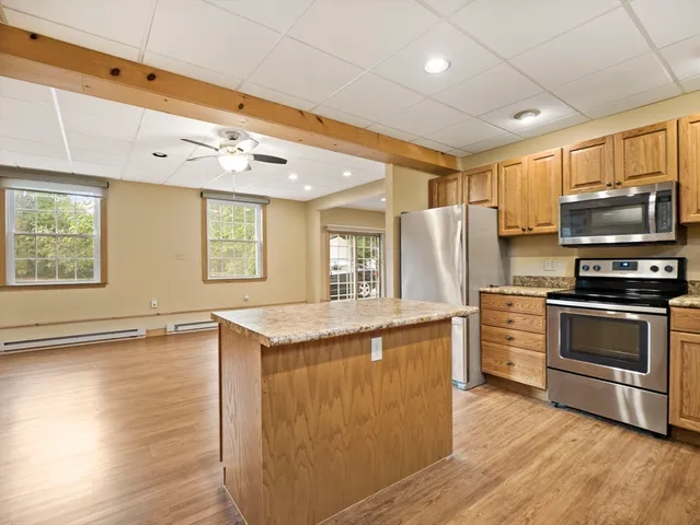 a kitchen with granite countertop a stove and a refrigerator