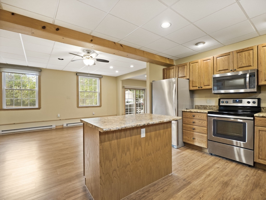 15 South Holden Road Warwick, MA 01378 - Photo 10 of 42 a kitchen with granite countertop a stove and a refrigerator