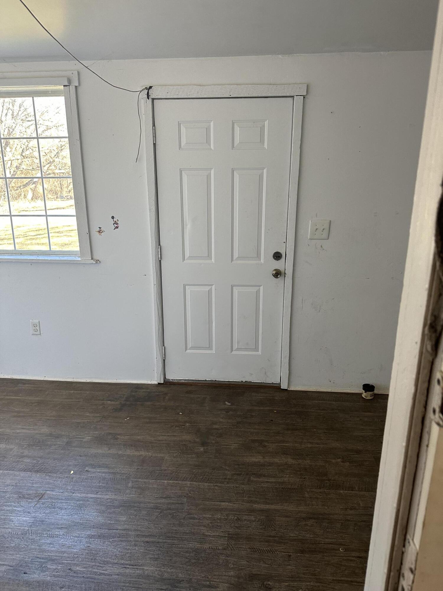 579-581 Botetourt Road Fincastle, VA 24090 - Photo 14 of 30 a view of an empty room with wooden floor and a window