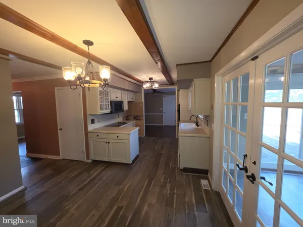 a room with lot of furniture and chandelier