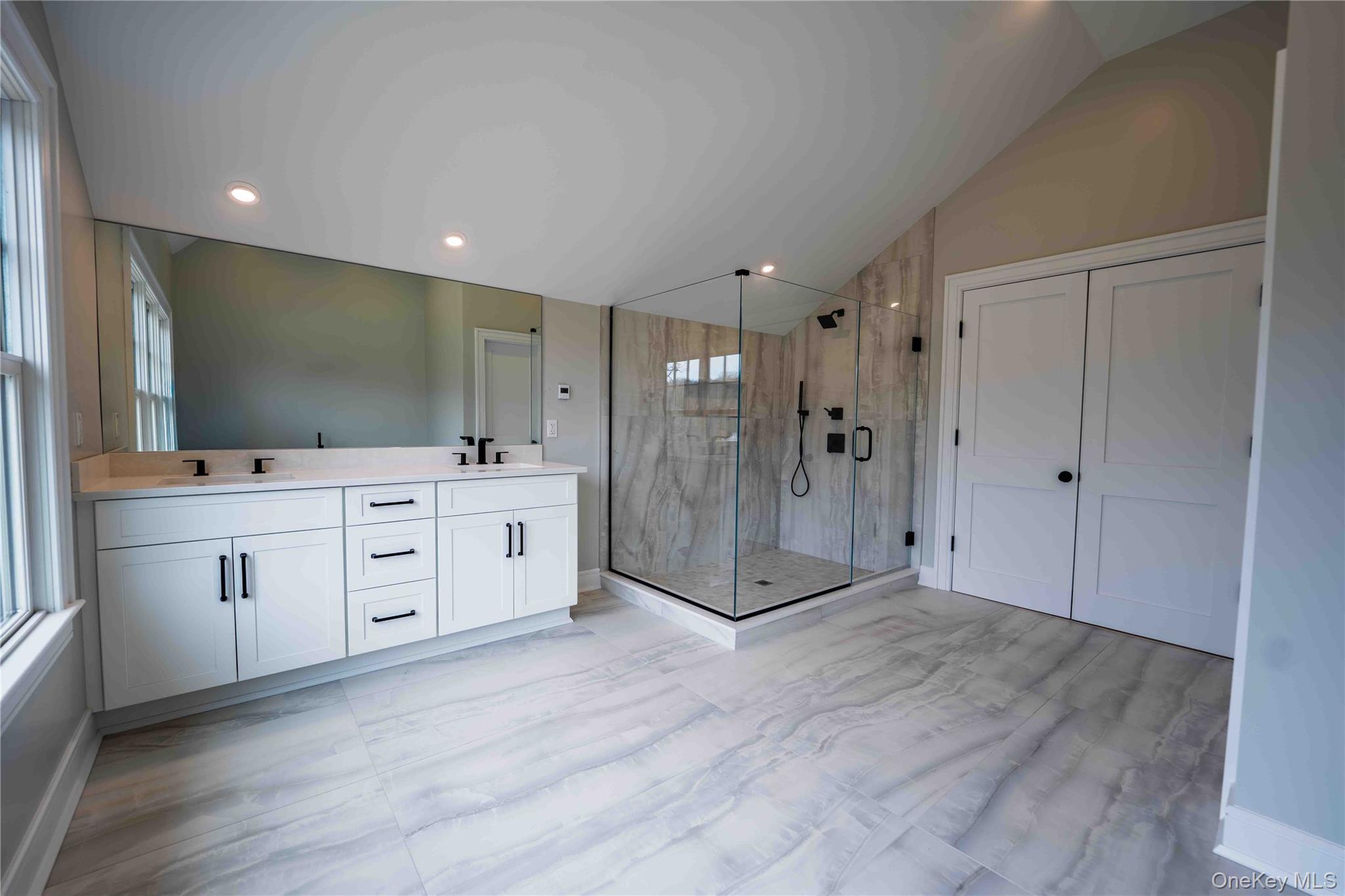 106 Cove Road Asharoken, NY 11768 - Photo 25 of 46 Full bathroom featuring double vanity, a marble finish shower, vaulted ceiling, and recessed lighting