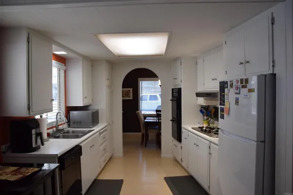 a kitchen with refrigerator and cabinets