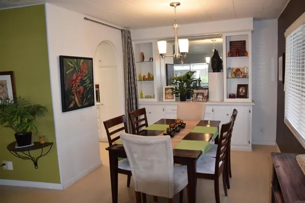 a dining room with furniture and window