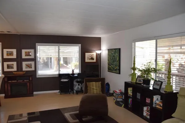 a living room with furniture window and wooden floor