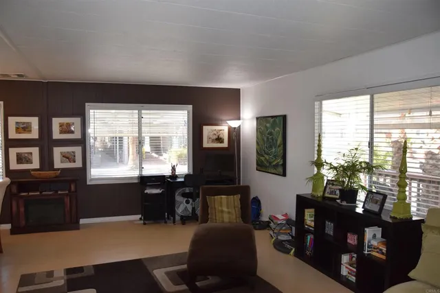 a living room with furniture window and wooden floor