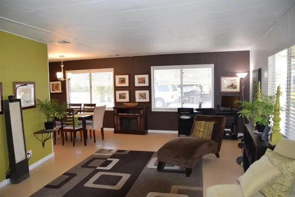 a living room with furniture and large windows