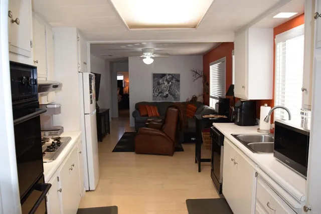 a kitchen with a refrigerator and a sink