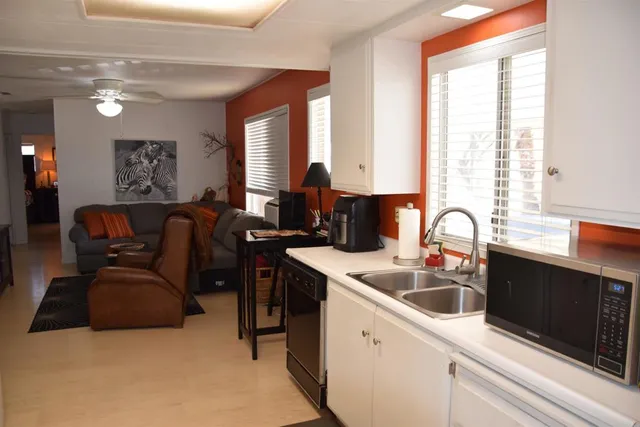a kitchen that has a sink and a stove in it