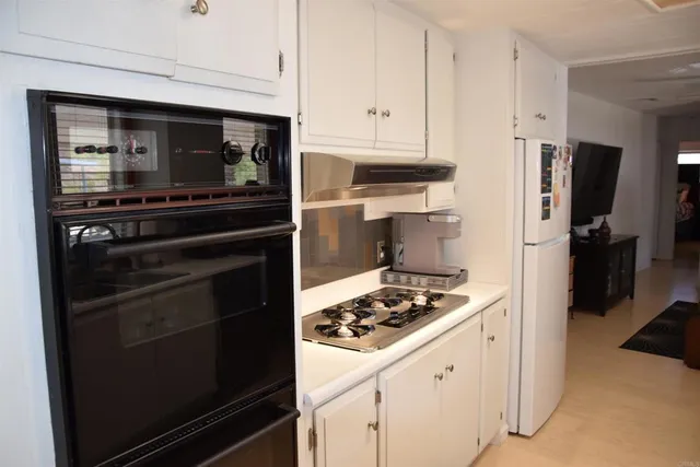a kitchen with appliances and cabinets
