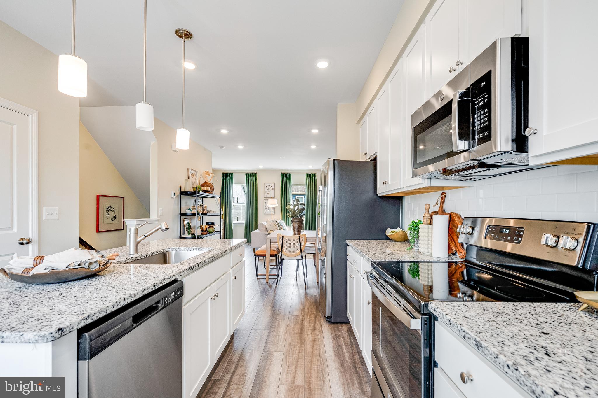 456 18th Avenue Ranson, WV 25438 - Photo 17 of 37 a large kitchen with stainless steel appliances granite countertop a lot of counter space and wooden floor