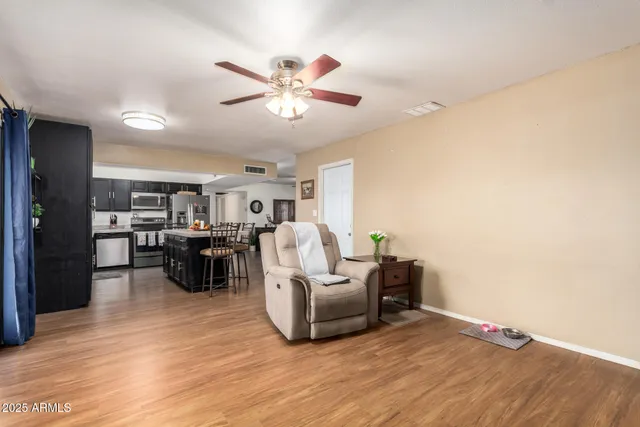 a living room with furniture and a wooden floor