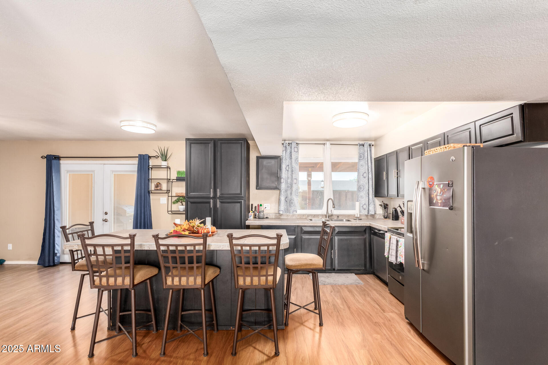 3341 West Pershing Avenue Phoenix, AZ 85029 - Photo 15 of 36 a large kitchen with a table chairs refrigerator and cabinets