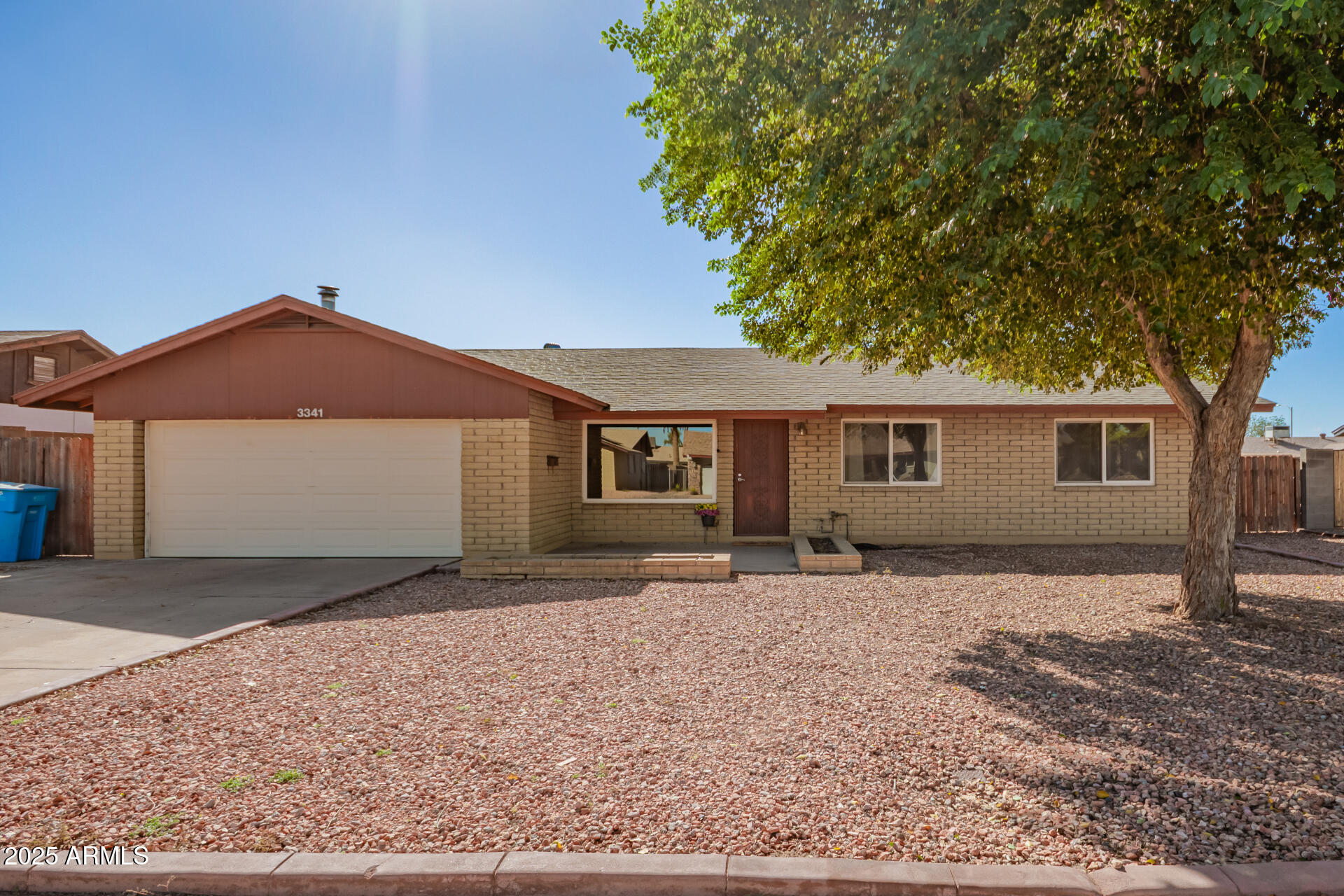 3341 West Pershing Avenue Phoenix, AZ 85029 - Photo 2 of 36 a front view of a house with a yard and trees
