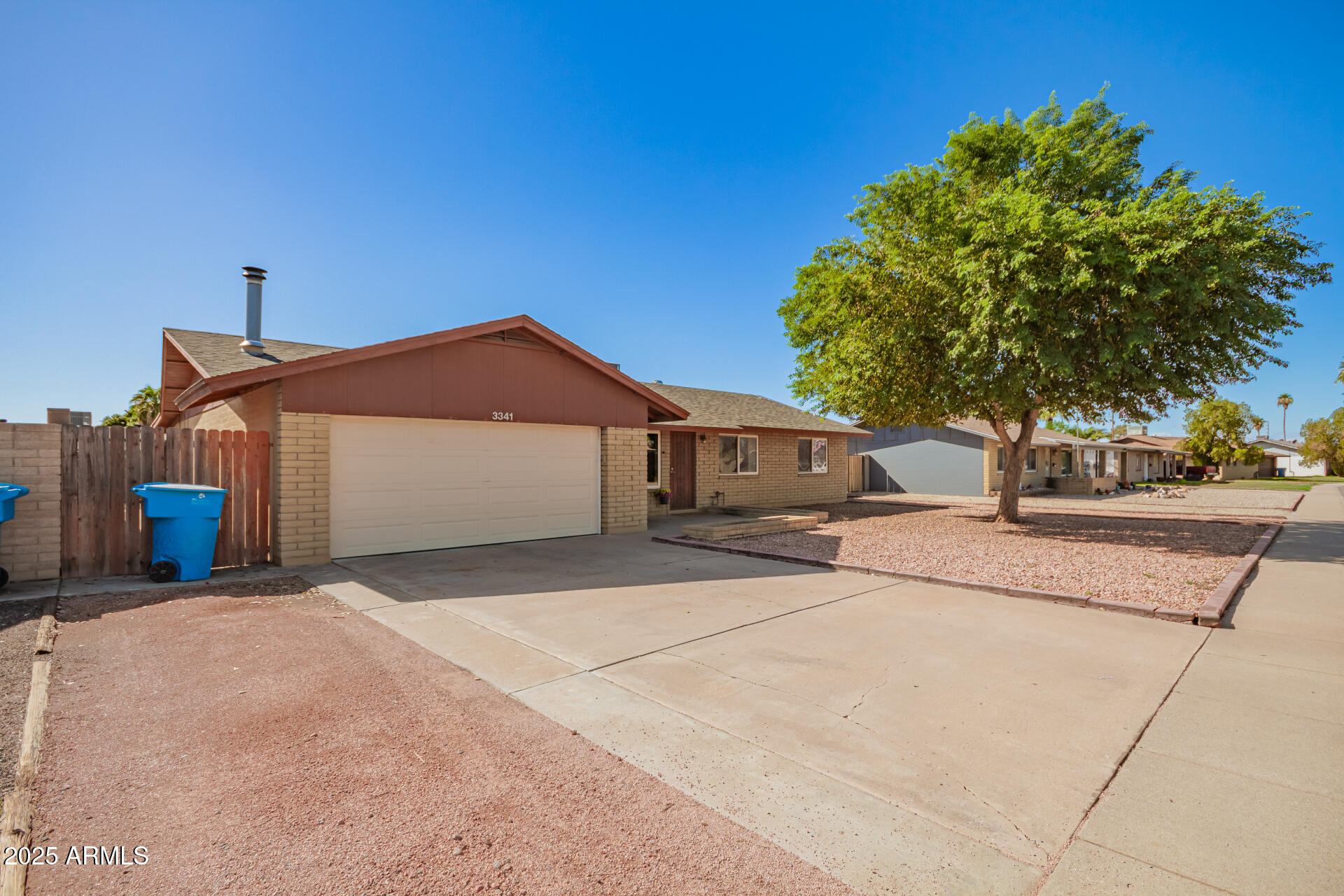 3341 West Pershing Avenue Phoenix, AZ 85029 - Photo 3 of 36 a front view of a house with a yard and garage