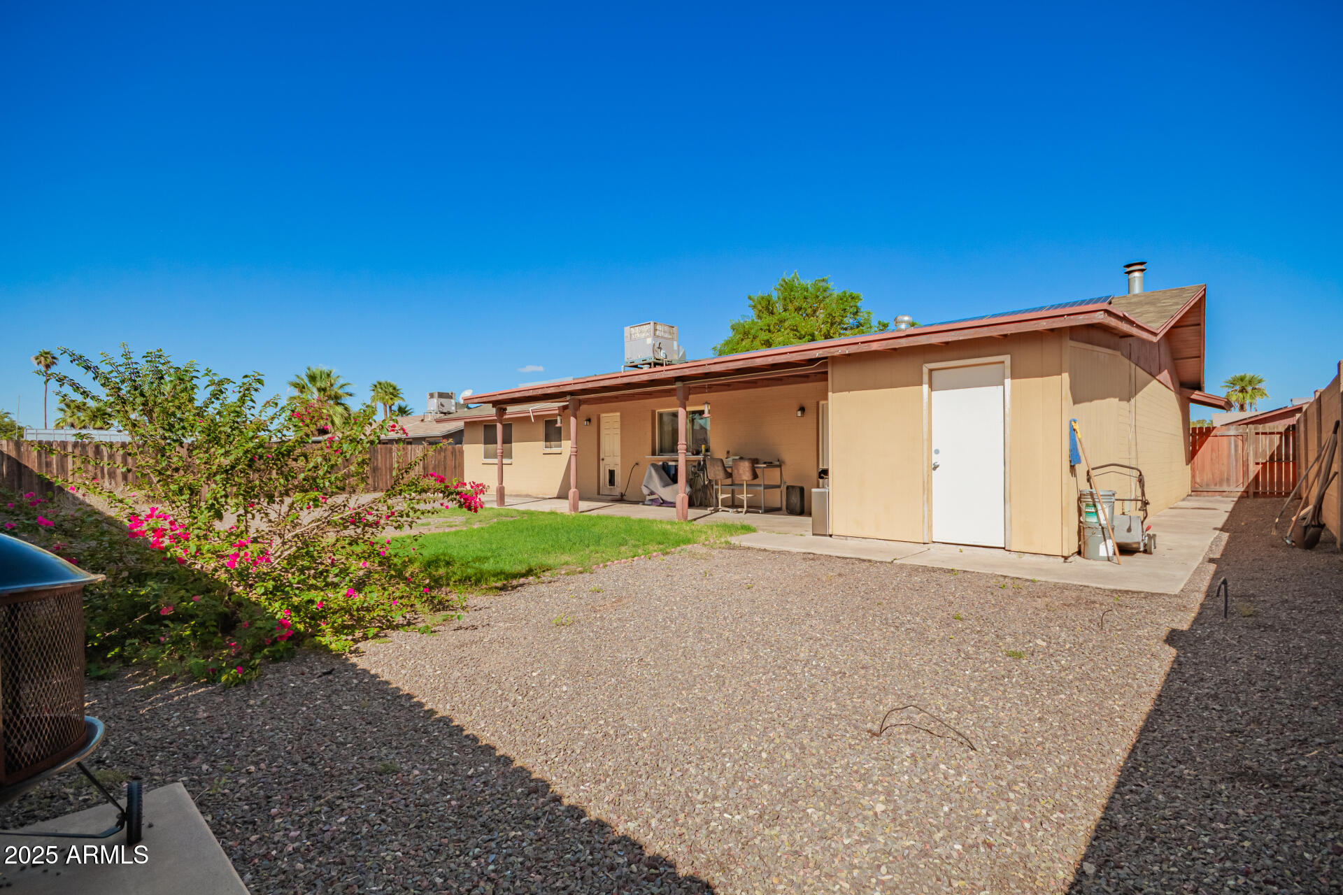 3341 West Pershing Avenue Phoenix, AZ 85029 - Photo 35 of 36 a front view of a house with a yard and potted plants