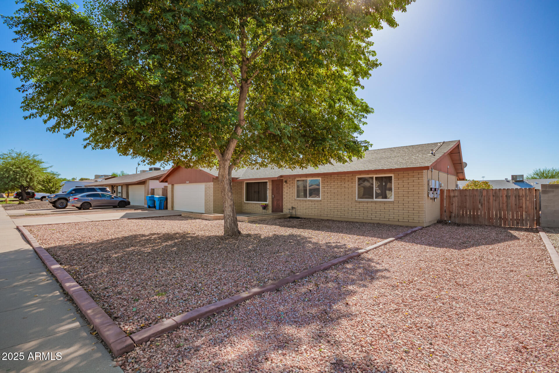 3341 West Pershing Avenue Phoenix, AZ 85029 - Photo 5 of 36 a front view of a house with a yard and garage