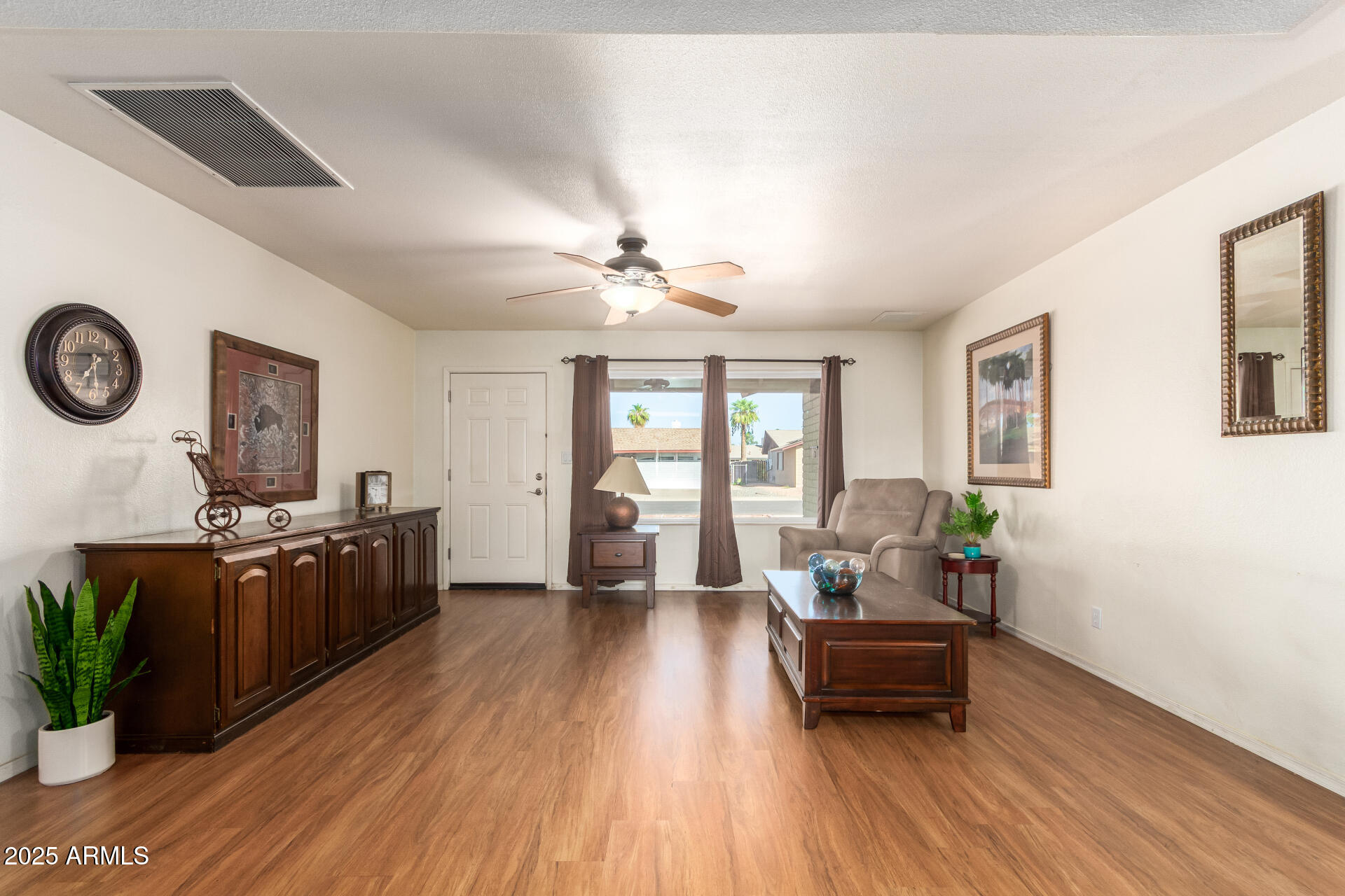 3341 West Pershing Avenue Phoenix, AZ 85029 - Photo 9 of 36 a living room with furniture and wooden floor