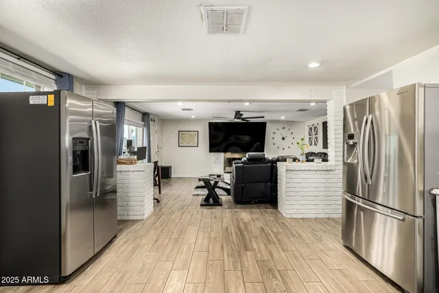 a kitchen with stainless steel appliances a refrigerator and a stove top oven