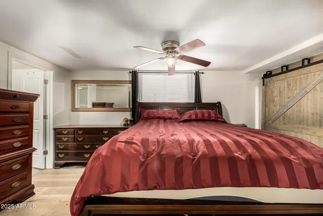 a bedroom with a bed and dresser