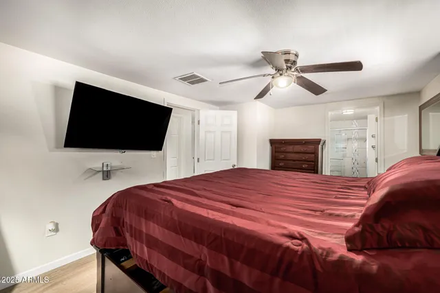 a bedroom with a bed and a flat screen tv