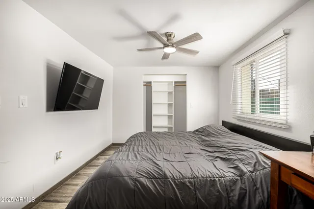 a bedroom with a bed and a flat screen tv