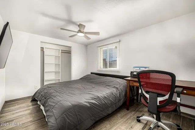 a bedroom with bed and chair