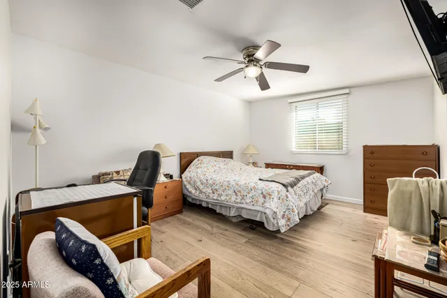 a bedroom with furniture and wooden floor