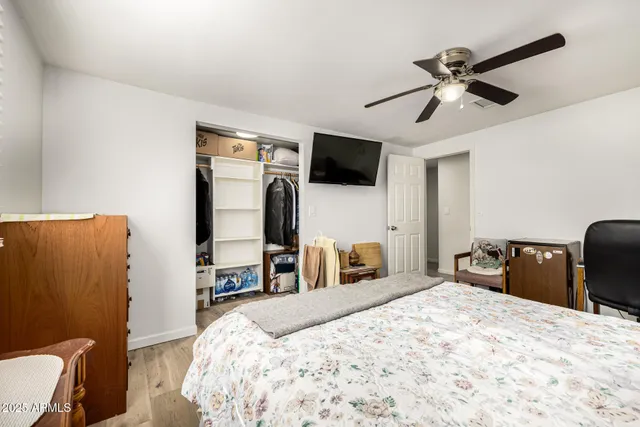 a bedroom with a bed and a flat screen tv